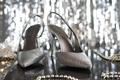Formal evening wear, silver high heels against grey glittery background. - PhotoDune Item for Sale