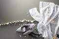 Formal evening wear silver high heels and glittery dress laying on the grey background. - PhotoDune Item for Sale