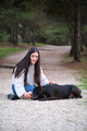 Young caucasian woman training her mixed breed dog to lay down. - PhotoDune Item for Sale