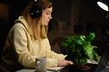 Woman Listening Music In Headphones And Using Laptop At Night. - PhotoDune Item for Sale