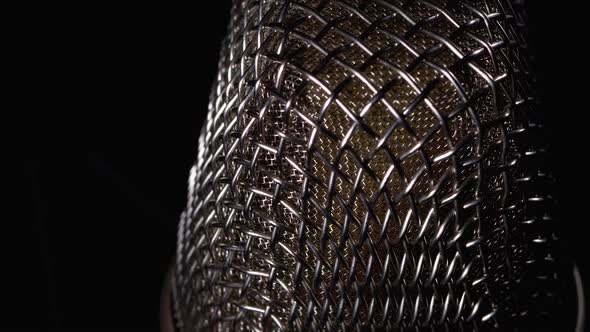 Studio Condenser Microphone Rotates on Black Background