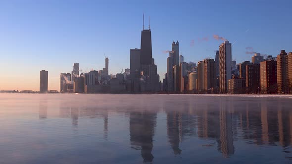 early morning of Chicago skyline with sea smoke on Lake Michigan during polar vortex 4k