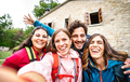 Young people group taking selfie at trekking excursion by countryside cottage - PhotoDune Item for Sale