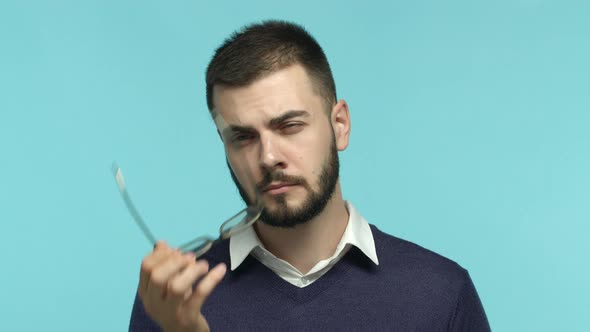 Close of Handsome Caucasian Bearded Man Businessman Taking Off Glasses and Looking Up with Pensive