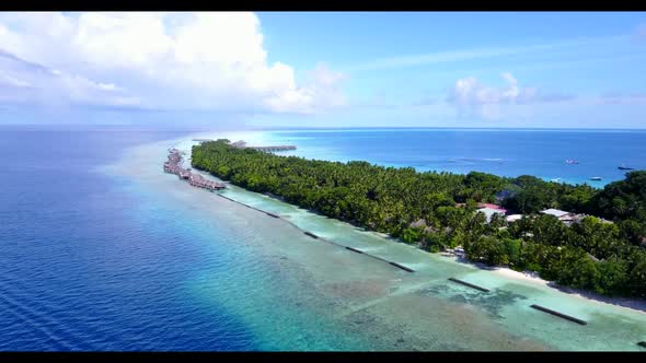 Aerial above sky of idyllic resort beach time by clear ocean and white sandy background of adventure