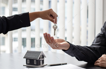 anding it to the customer after signing the house purchase contract with home insurance, Trading of mortgages and insurance concept.