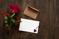 Red rose with postcard on wooden background. - PhotoDune Item for Sale