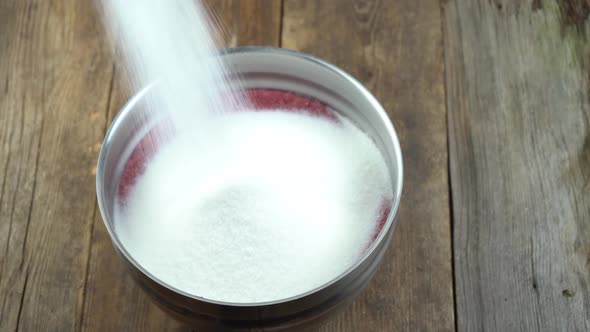 Sip Sugar Into a Bowl with Red Currants