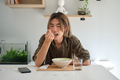 Asian young man eating soup in the living room. - PhotoDune Item for Sale