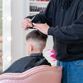 The hairdresser makes a boy's haircut with a clipper - PhotoDune Item for Sale
