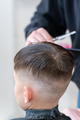 The hairdresser makes a boy's haircut with a clipper - PhotoDune Item for Sale