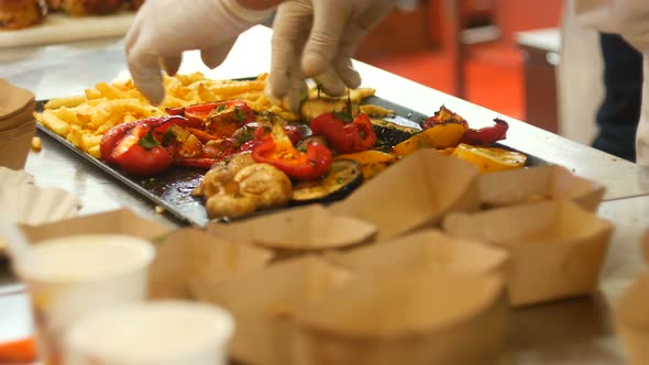 Chef Serves French Fries And Baked Vegetables