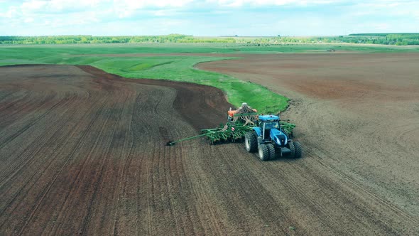 Sowing Machine Is Riding Along the Field