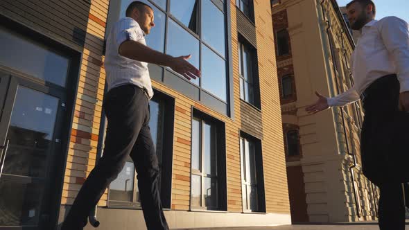 Young Male Managers Meeting in City and Greeting Each Other