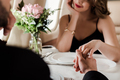 selective focus of man and woman holding hands while sitting at served table in plane - PhotoDune Item for Sale