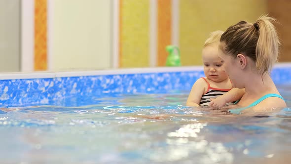 First Swimming Lesson in the Pool with a Trainer