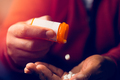 close up of man at home sitting down handling prescription pill bottle - PhotoDune Item for Sale