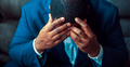 Black or African American business man sitting down looking anxious and depressed - PhotoDune Item for Sale