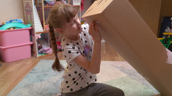 Girl Unpacking The Doll