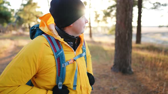 Man Backpacker Walking on Pine Forest