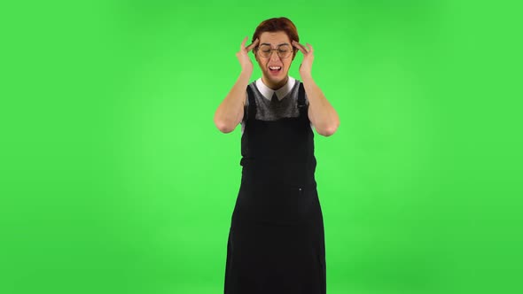 Funny Girl in Round Glasses Is Suffering From Headache From Fatigue. Green Screen