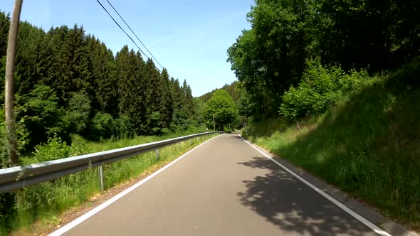 POV Driving on motorcycle on a scenic road in Eifel National Park in Germany