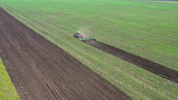 Aerial View  Tractor Plows Field