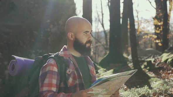 Traveler Holds a Tourist Map in His Hands