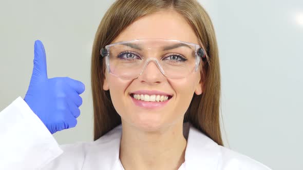 Thumbs Up by Female Scientist in Laboratory