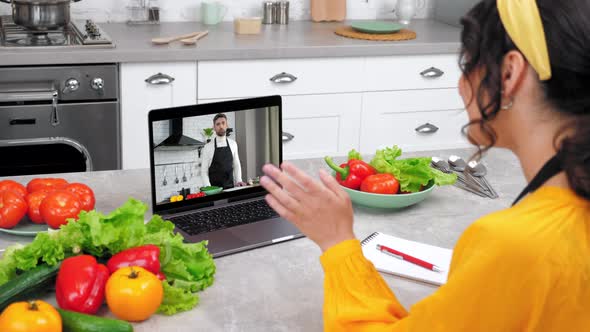 Smiling Woman in Home Kitchen Study Online Video Call Laptop Listen Chef Teacher