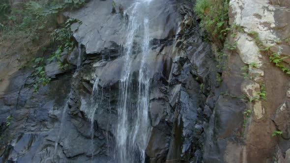 Water Flowing Down To Rocky Cliff Of Cascada de Yelapa In Jalisco, Mexico. - aerial, closeup