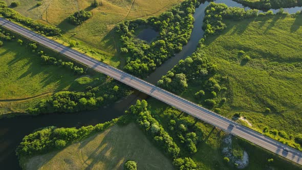 Countryside. A Wide Canal That Flows Between Fields And Forests And A Highway