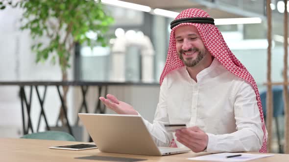 Online Payment Success on Laptop for Arab Businessman 