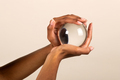 Crop black woman holding transparent glass sphere - PhotoDune Item for Sale