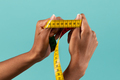 Black female hands showing measuring tape - PhotoDune Item for Sale