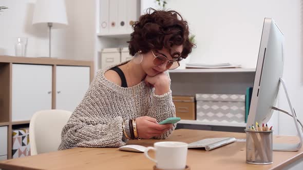 Young Woman Scrolling and Texting Using her Smartphone