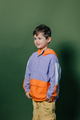 Cute little boy in vintage sport suit on green background - PhotoDune Item for Sale