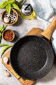 Empty skillet, vegetables, spices and herbs on gray stone background.  - PhotoDune Item for Sale