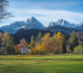 German house with red roof on a field with Alps Mountains - Schwangau, Bavaria, Germany - PhotoDune Item for Sale