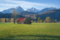 Wooden house with red roof on a field with Alps Tannheim Mountains - Schwangau, Bavaria, Germany - PhotoDune Item for Sale