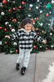 Lifestytle portrait of happy little toddler girl running near Christmas tree - PhotoDune Item for Sale