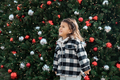 Lifestyle portrait of toddler girl smiling near Christmas tree  - PhotoDune Item for Sale
