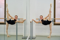 Young ballerina practicing ballet pose in a ballet school. - PhotoDune Item for Sale