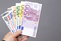 European money in the hand on a gray background - PhotoDune Item for Sale