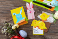 Easter congratulation cards with Easter bunny and chickens on a wooden table.  - PhotoDune Item for Sale
