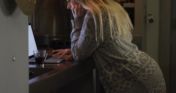 Caucasian woman concentrated and working in her house