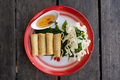 Top down view of four Thai springrolls on a traditional plate - PhotoDune Item for Sale