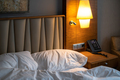 Hotel room with a comfortable bed, clock and modern decor - PhotoDune Item for Sale
