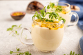 Yogurt with passionfruit and marigold microgreen in glass on gray. Side view, selective focus. - PhotoDune Item for Sale