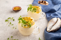 Yogurt with passionfruit and marigold microgreen in glass on gray. Side view, close up. - PhotoDune Item for Sale